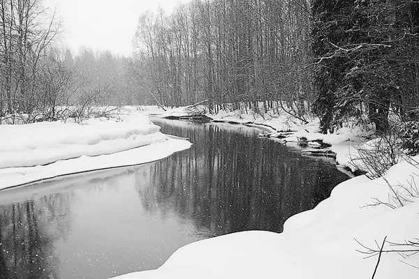 river and snowy field, winter mist in panoramic landscape