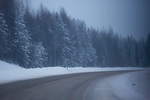 snow and fog on winter road, winter lonely landscape