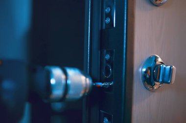 installation of lock in the door, closeup, security concept clipart