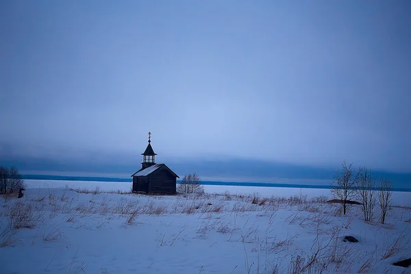 lonely wooden church in the field, architecture in the winter landscape