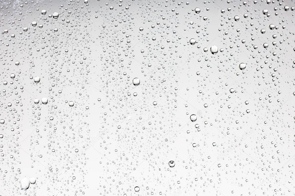 gray wet background, raindrops on window glass, concept of autumn weather