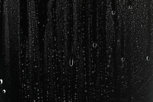 black wet background, raindrops on window glass, concept of autumn weather