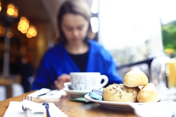 woman drinking cup of coffee for breakfast in a cafe in modern interior, a European breakfast