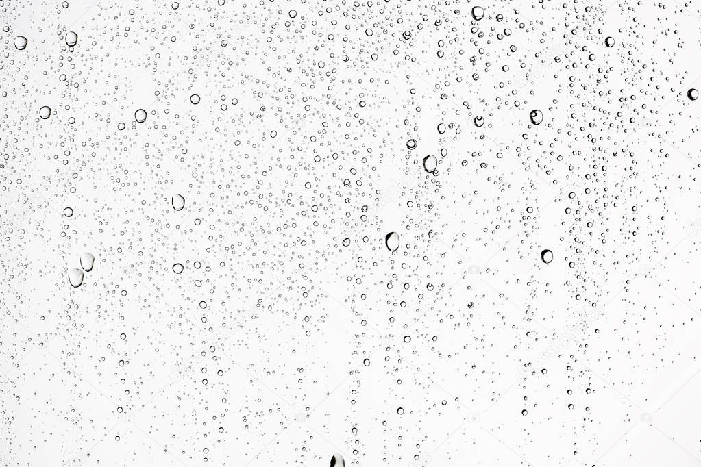 white wet background, raindrops on window glass, concept of autumn weather