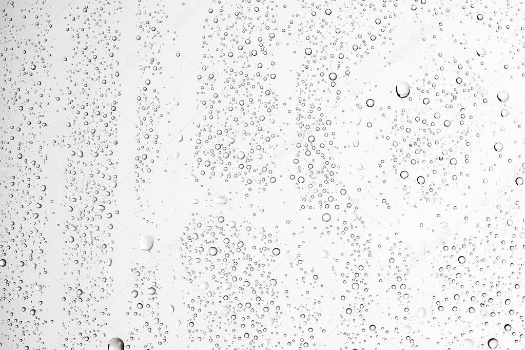 white wet background, raindrops on window glass, concept of autumn weather