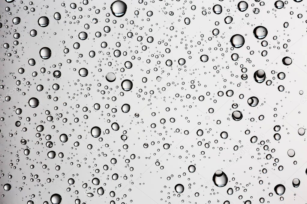 gray wet background, raindrops on window glass, concept of autumn weather