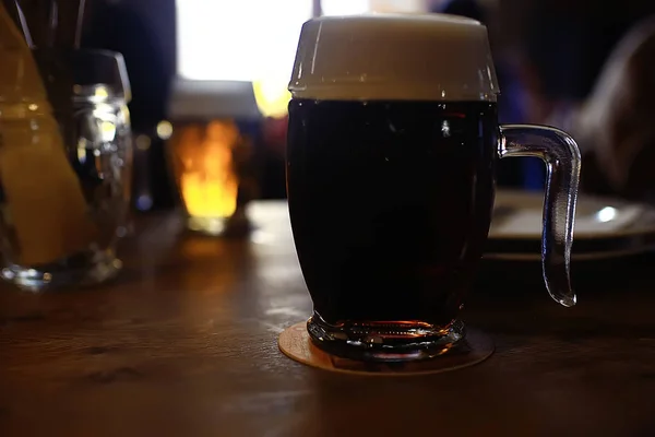 mug of dark beer in the interior of  pub, pint of beer with foam on served table in  restaurant in Czech Republic