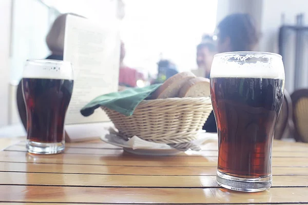 mug of dark beer in the interior of  pub, pint of beer with foam on served table in  restaurant in Czech Republic