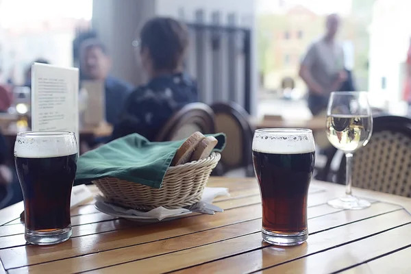 mug of dark beer in the interior of  pub, pint of beer with foam on served table in  restaurant in Czech Republic