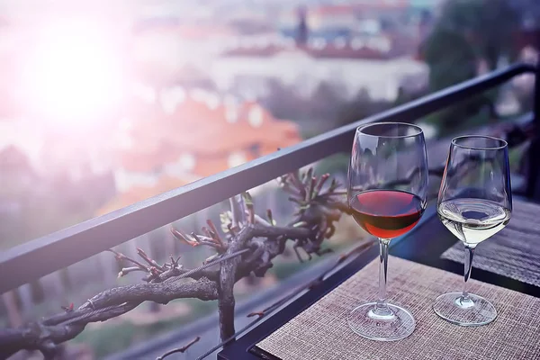 glasses of white and red wine on terrace