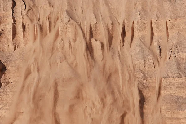 texture of  sand drowned by dunes. Sand avalanche is showered off the dune