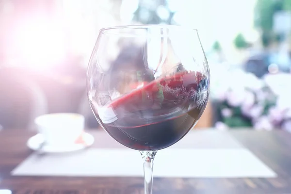 red wine splashing in a glass in a cafe