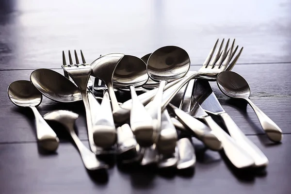 forks, spoons and knives on table, beautiful serving tableware