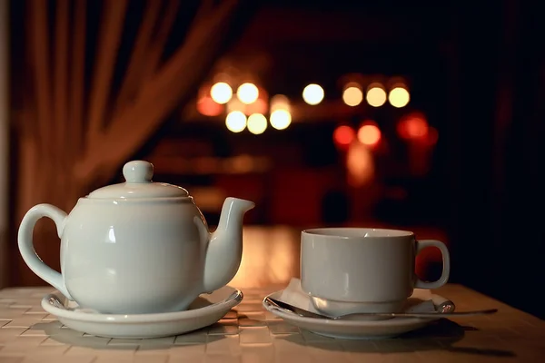 English tea in cafe, cup and kettle with five o\'clock tea