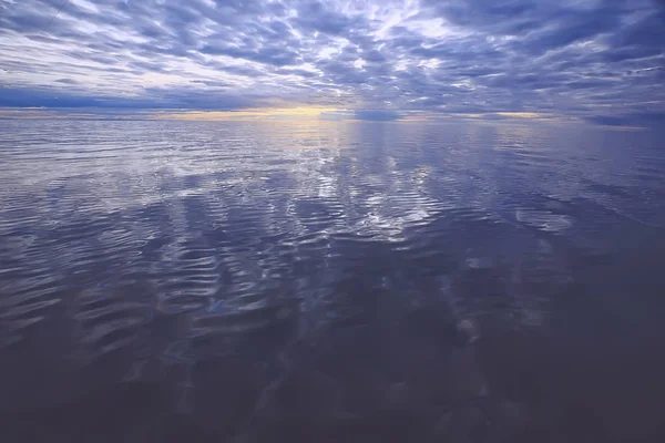 sky above water / texture background, horizon sky with clouds on the lake