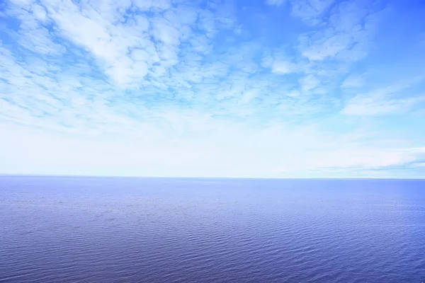 sky above water / texture background, horizon sky with clouds on the lake