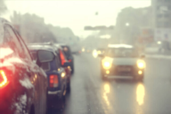 cars on winter road traffic jam city / winter weather on the city highway, the view from car in the fog and snow road