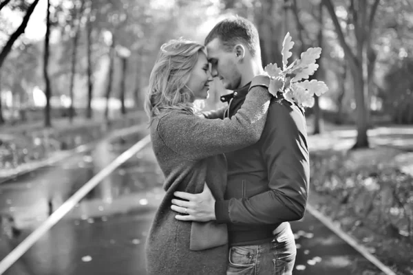 autumn landscape with people in the park / gerfrend and boyfriend hug in autumn park, fall view person