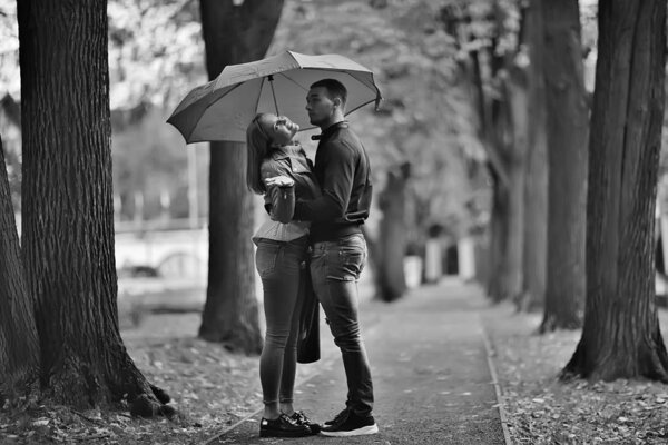 Autumn landscape with people in the park / gerfrend and boyfriend hug in autumn park, fall view person