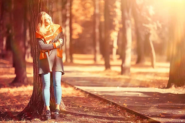 autumn view, people in the park on the background of autumn trees / beautiful autumn concept weather fall