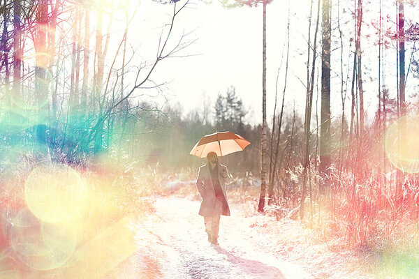 Winter walk with an umbrella / man in a coat with an umbrella, walk against the backdrop of the winter landscape, winter view