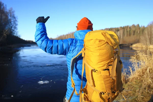 winter landscape man with a backpack / nature landscape a man on a hike with equipment in snowy weather in Canada