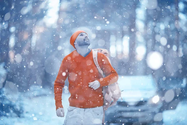 tourist in the winter forest / the guy travels against the backdrop of a winter landscape with forest, snow and trees