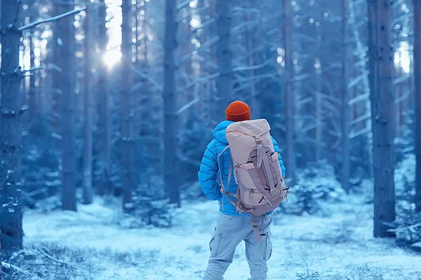 winter landscape man with a backpack / nature landscape a man on a hike with equipment in snowy weather in Canada