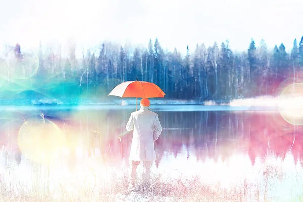 winter walk with an umbrella / man in a coat with an umbrella, walk against the backdrop of the winter landscape, winter view