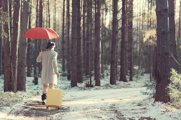 winter walk with an umbrella / man in a coat with an umbrella, walk against the backdrop of the winter landscape, winter view