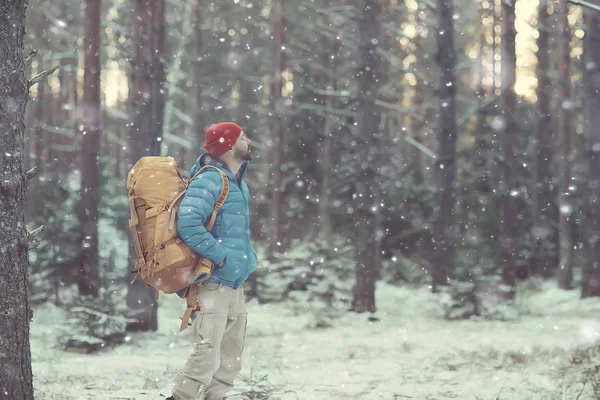 winter landscape man with a backpack / nature landscape a man on a hike with equipment in snowy weather in Canada