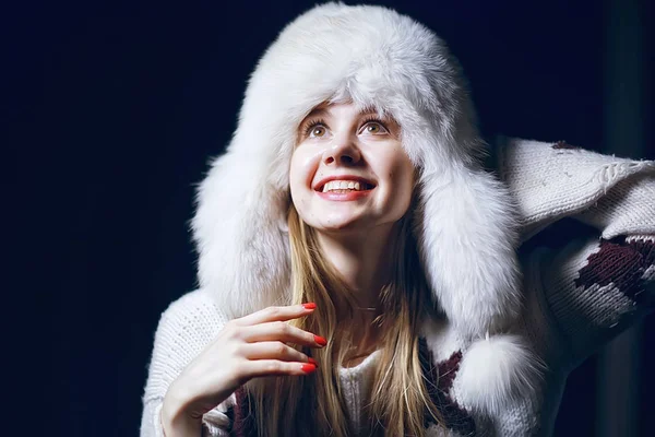 model in winter hat / beautiful adult girl in a big fur hat, winter clothes, Christmas holiday