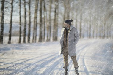 bir ceket / kış tarzı moda adam, kış manzara, karlı hava, sıcak giysilerin fon karşı yürümek