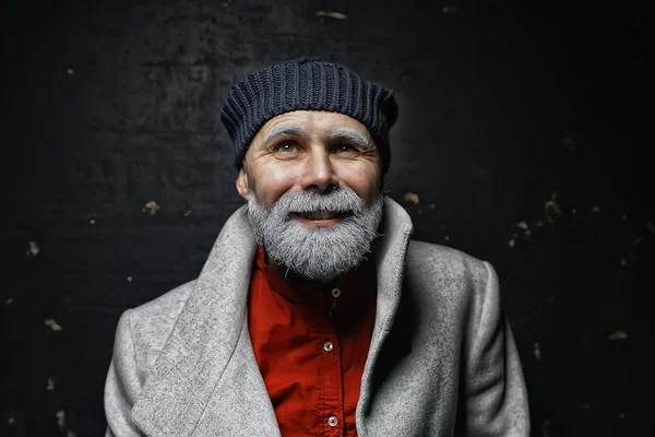 brutal man with a beard in winter clothes / portrait person with a gray beard, hipster warm clothes winter