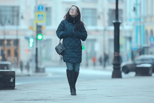 girl in a coat in the winter city / concept of fatigue stress christmas chores