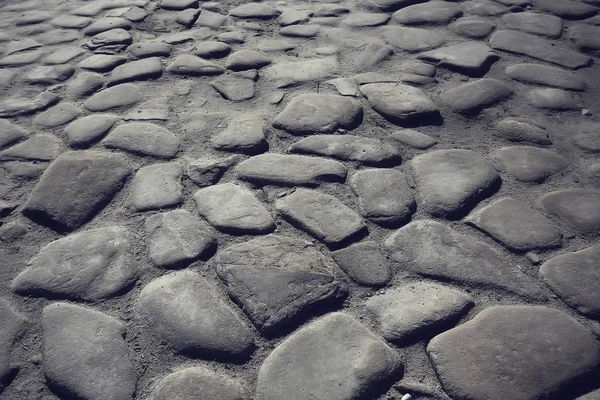 old stone pavement background / abstract pavement, large cobblestones, old road texture