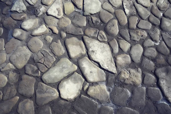 old stone pavement background / abstract pavement, large cobblestones, old road texture