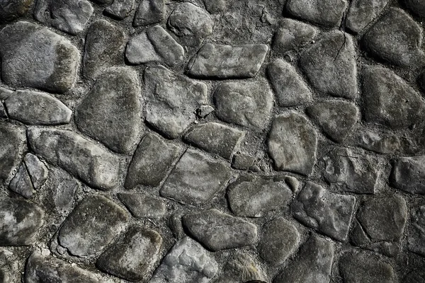 old stone pavement background / abstract pavement, large cobblestones, old road texture