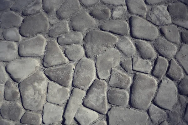 old stone pavement background / abstract pavement, large cobblestones, old road texture