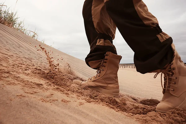 military exercises in the desert / legs in army boots, soldiers of the desert