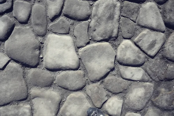 old stone pavement background / abstract pavement, large cobblestones, old road texture