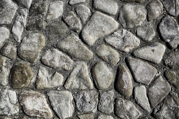 old stone pavement background / abstract pavement, large cobblestones, old road texture