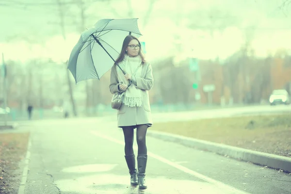 girl with umbrella in the city / urban view, landscape with a model in october