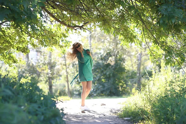 夏の遊び心のある大人の若い女の子がジャンプ 公園で陽気な美しいモデル 夏は短いスカートで見て — ストック写真