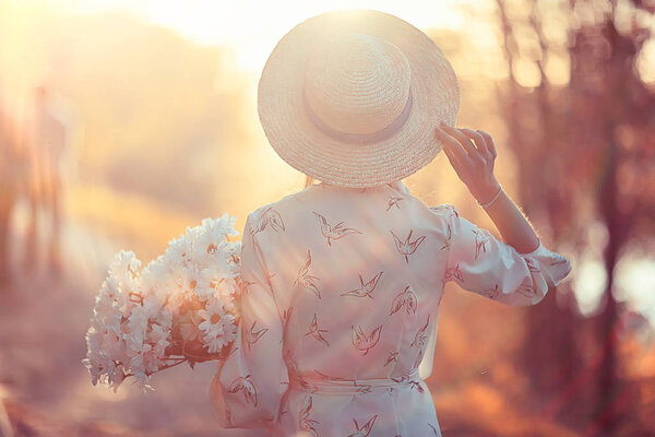 happy girl with flowers in the city / summer photo young beautiful girl holding a bouquet of flowers on a city street