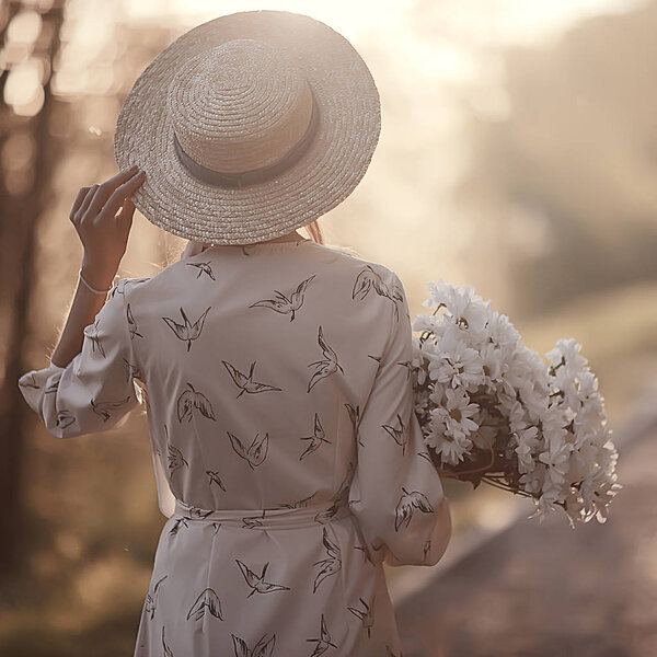 girl waiting for a city date / happy girl with a bouquet of flowers walking in the urban landscape, soft light