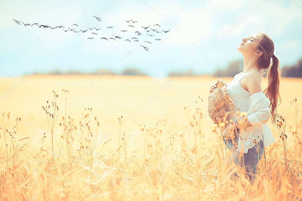 happy girl in autumn field with spikelets landscape / adult young girl portrait, summer look, nature