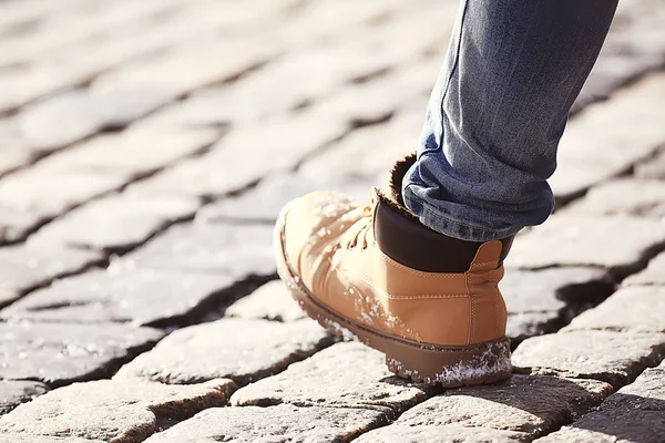 mans foot in a shoe on a paving block, a pedestrian,