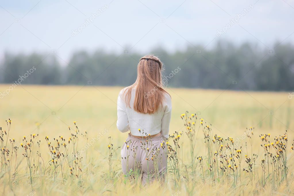 blonde with long hair in autumn field / concept of happiness health young adult model in summer landscape