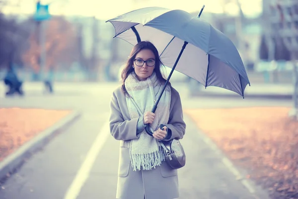 girl with umbrella in the city / urban view, landscape with a model in october